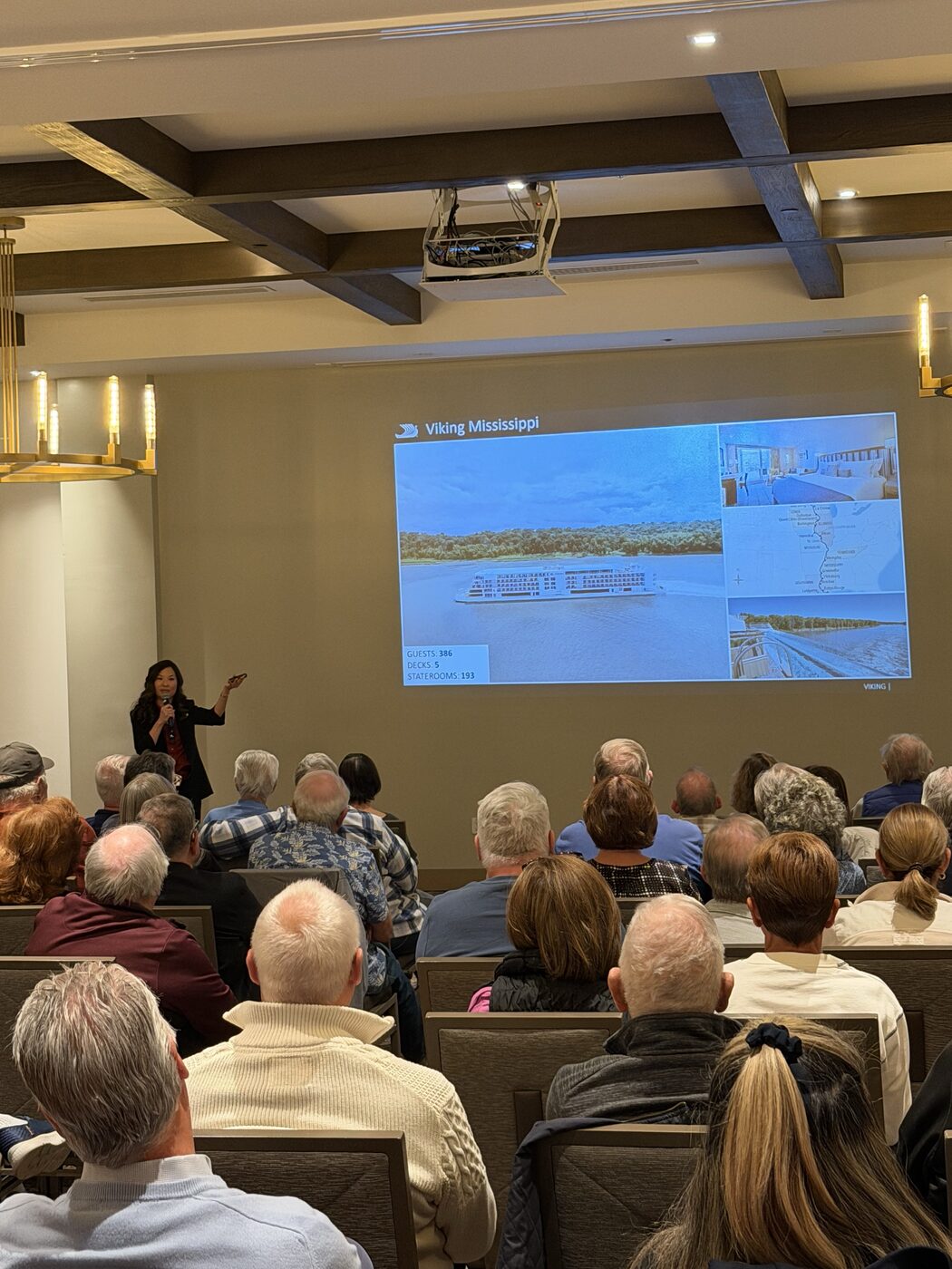Guests watching a Viking Mississippi river cruise presentation at an Expedia Cruises Palm Desert event